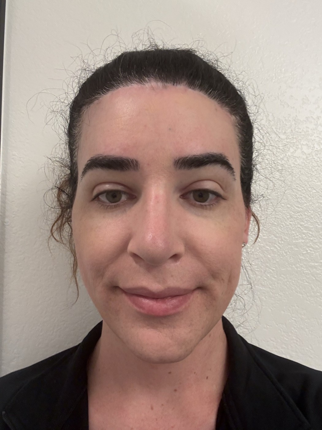 Face mid-routine after bronzer and blush: depth has returned with bronzer along the jaw and temples, warm blush on the cheeks; the skin has dimension compared to the flat even tone after foundation alone