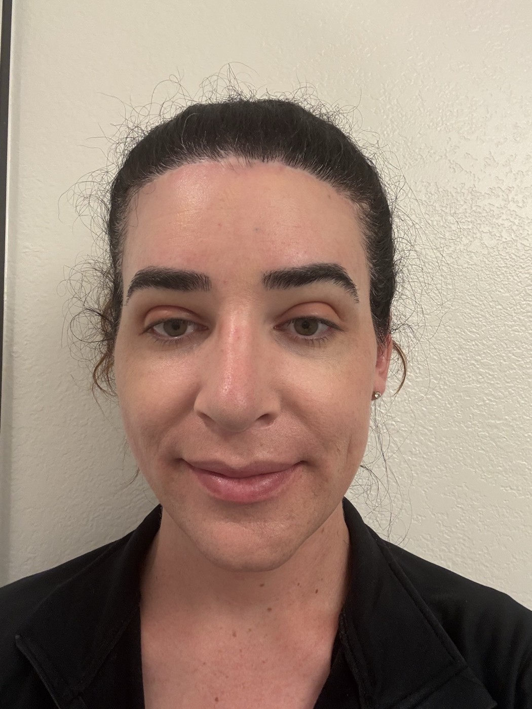 Completed makeup look: even complexion, subtle depth from bronzer along the jaw and temples, blush on the cheeks, and rose eyeshadow on the lids